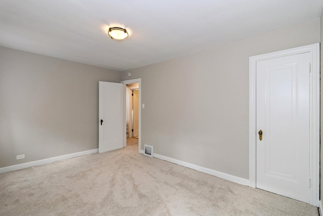 empty room with light colored carpet