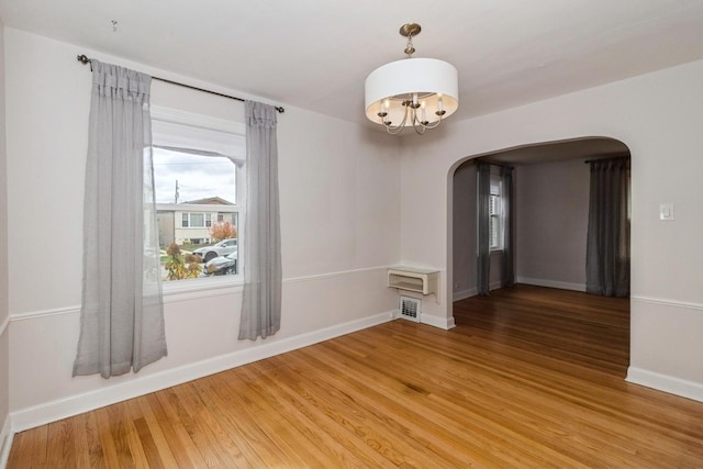 unfurnished room with wood-type flooring