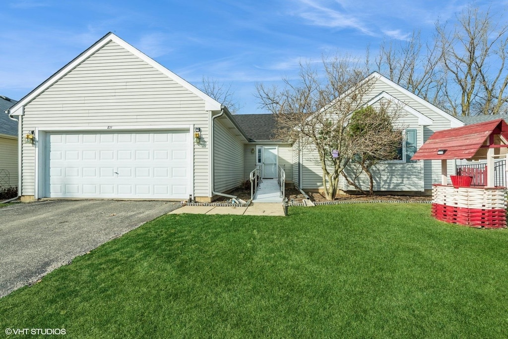 view of front of home with a garage and a front lawn