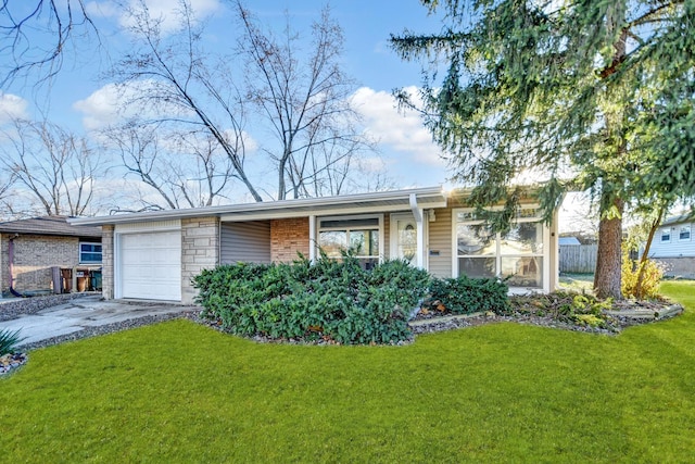 single story home featuring a garage and a front lawn