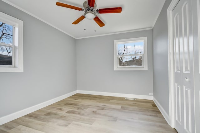 unfurnished room featuring ceiling fan, ornamental molding, and light hardwood / wood-style flooring