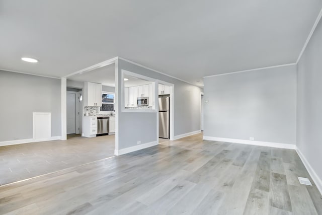 unfurnished living room with light hardwood / wood-style flooring and ornamental molding