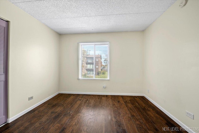 empty room with dark hardwood / wood-style floors