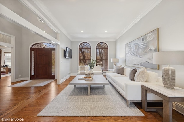 living room with hardwood / wood-style floors and ornamental molding