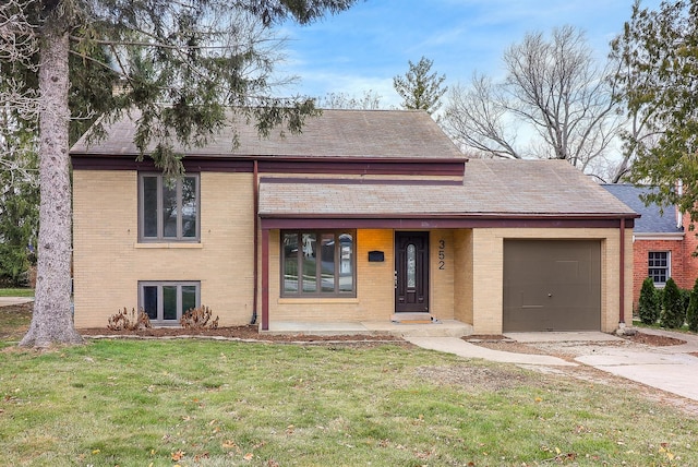 tri-level home featuring a front yard and a garage