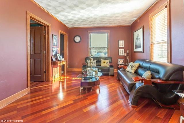 living room with hardwood / wood-style flooring and crown molding