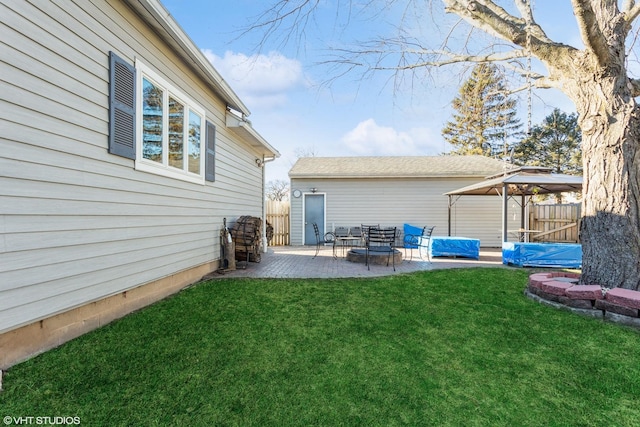 rear view of property with a gazebo, a patio area, and a yard