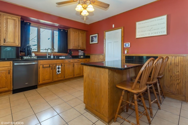 kitchen with kitchen peninsula, light tile patterned floors, a breakfast bar, and stainless steel dishwasher