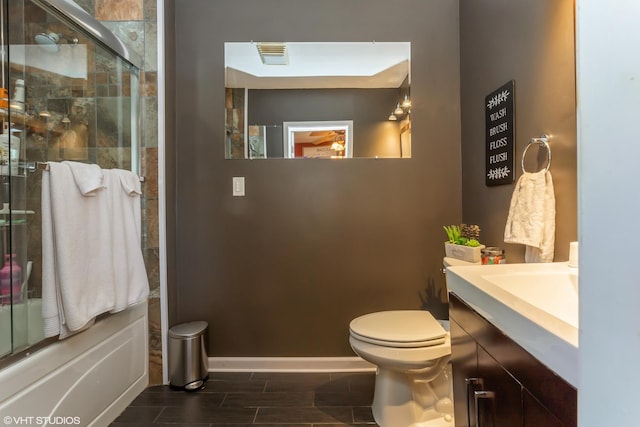 full bathroom with vanity, toilet, and enclosed tub / shower combo