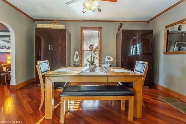 dining room with dark hardwood / wood-style flooring and crown molding