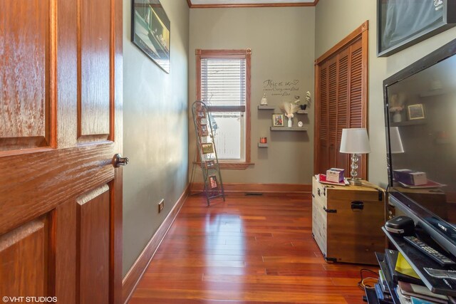 interior space with dark hardwood / wood-style floors and crown molding