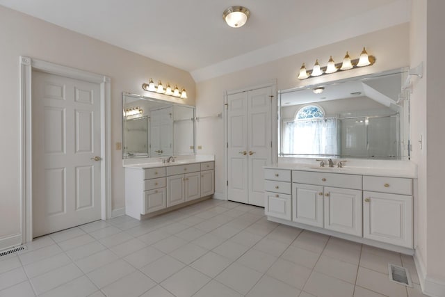 bathroom featuring tile patterned flooring, vanity, an enclosed shower, and lofted ceiling