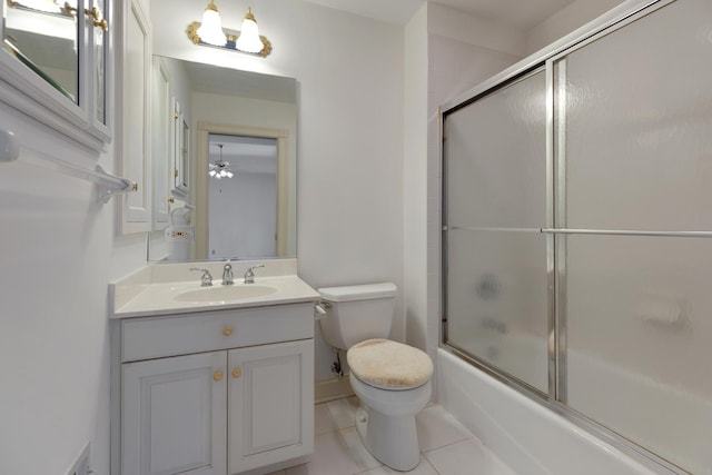 full bathroom with ceiling fan, tile patterned floors, combined bath / shower with glass door, toilet, and vanity