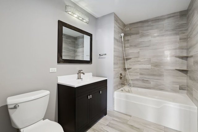 full bathroom with vanity, tiled shower / bath combo, and toilet