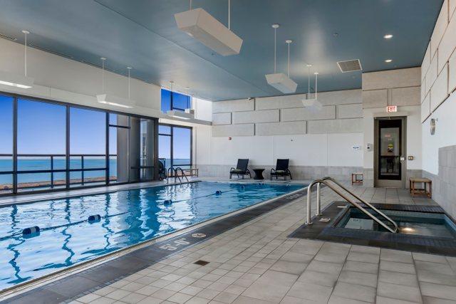 view of swimming pool featuring a water view