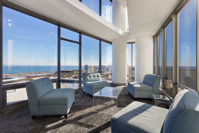 sunroom / solarium with a water view and plenty of natural light