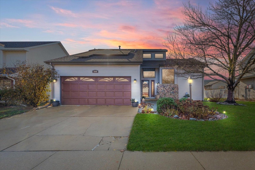 view of front of home featuring a yard and a garage