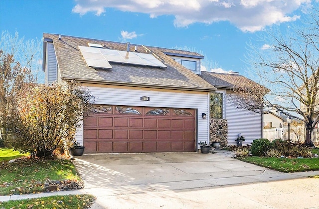 view of front of house with solar panels and a garage