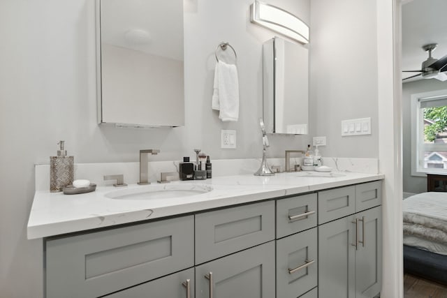 bathroom featuring hardwood / wood-style floors, ceiling fan, and vanity