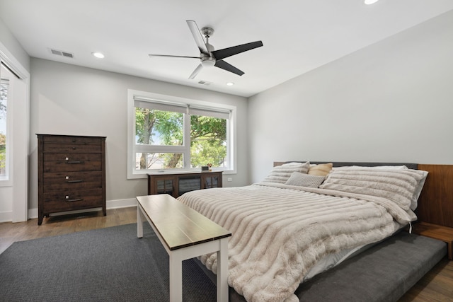 bedroom with dark hardwood / wood-style floors and ceiling fan