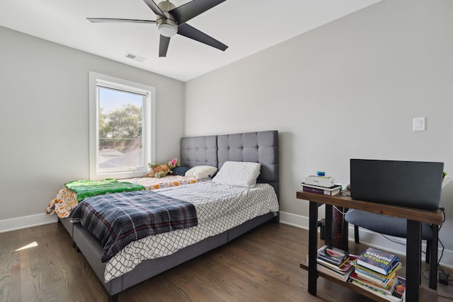 bedroom with ceiling fan and dark hardwood / wood-style flooring