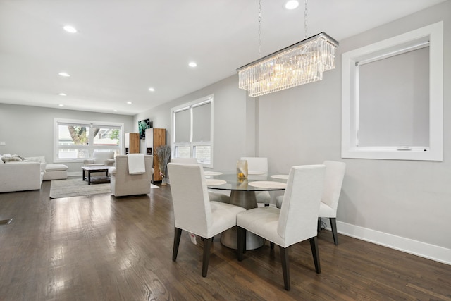 dining space featuring dark hardwood / wood-style floors and a notable chandelier