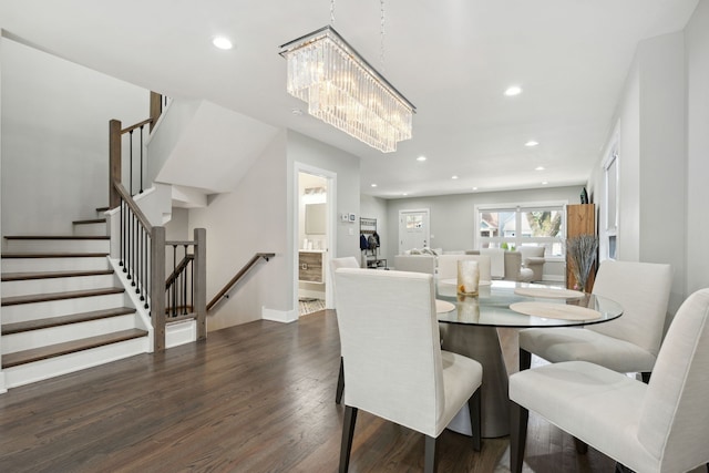 dining room with a chandelier and dark hardwood / wood-style floors