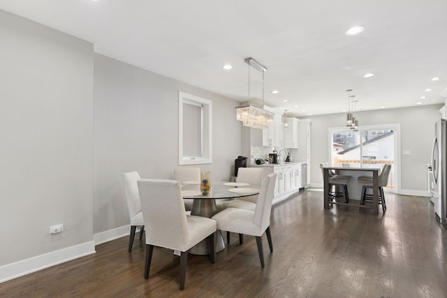 dining space with dark hardwood / wood-style flooring