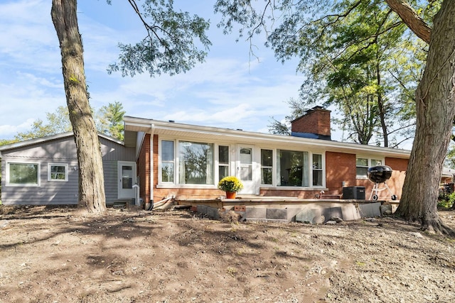 820 Exmoor Rd, Olympia Fields, IL 60461 - back of house with brick siding, a chimney, and central AC