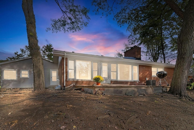 820 Exmoor Rd, Olympia Fields, IL 60461 - rear view of house featuring a chimney, brick siding, and central AC