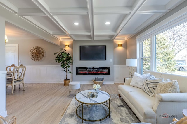 living room featuring beamed ceiling, light hardwood / wood-style floors, and coffered ceiling