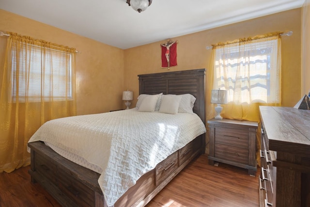 bedroom featuring hardwood / wood-style floors and multiple windows