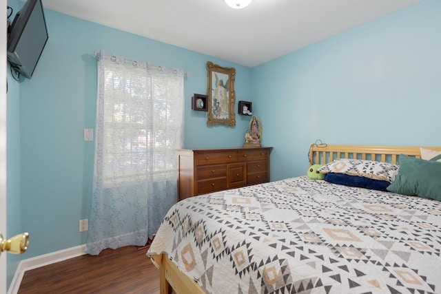 bedroom with dark hardwood / wood-style flooring