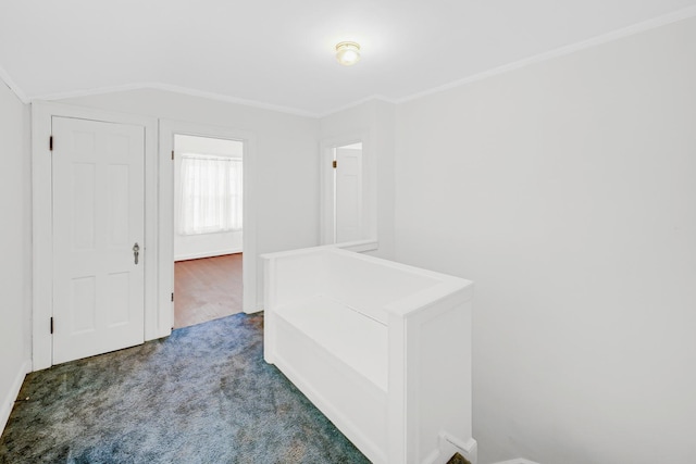 corridor with dark carpet and crown molding