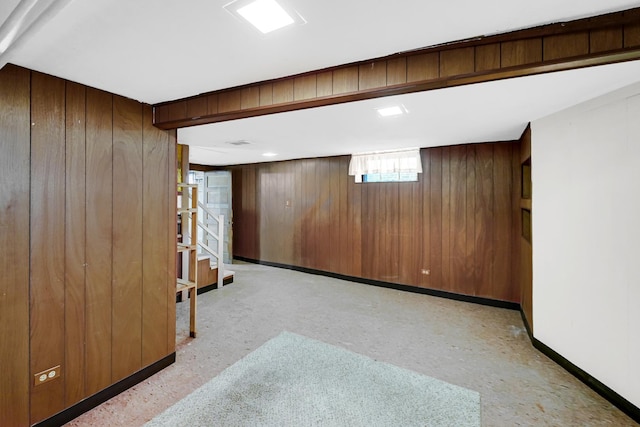 basement featuring wood walls