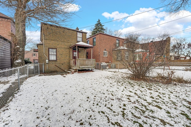 view of snow covered back of property