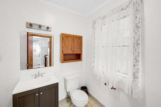 bathroom with tile patterned flooring, vanity, toilet, and crown molding