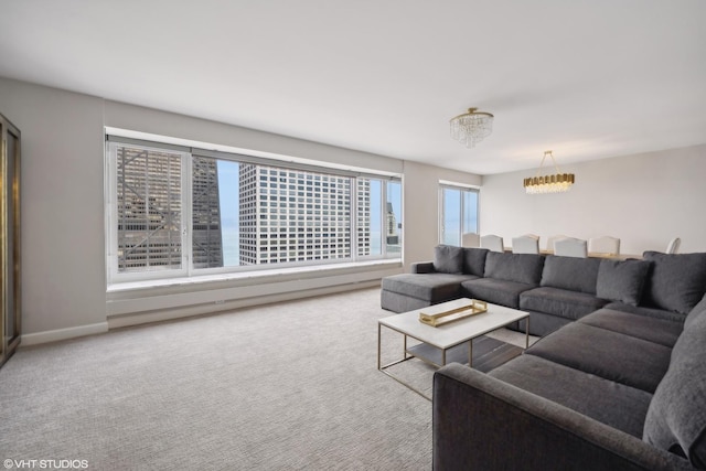 carpeted living room featuring a chandelier and a healthy amount of sunlight