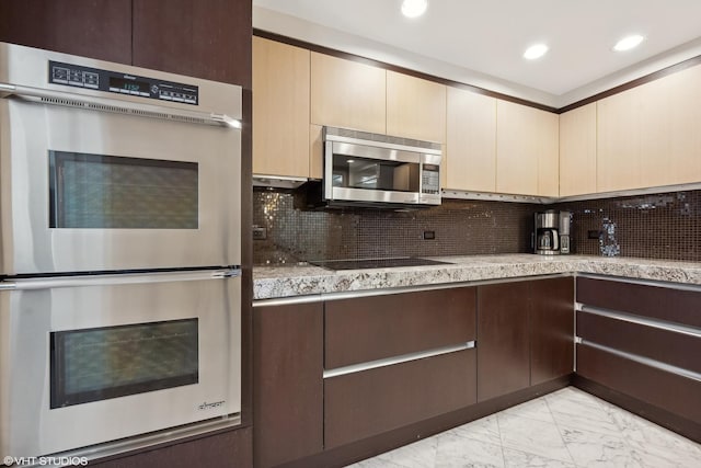 kitchen with decorative backsplash and appliances with stainless steel finishes