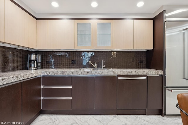 kitchen with decorative backsplash, sink, and stainless steel appliances