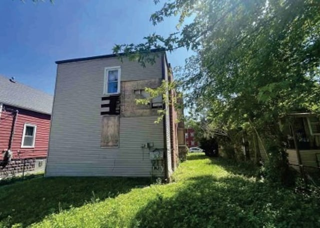 rear view of house featuring a lawn