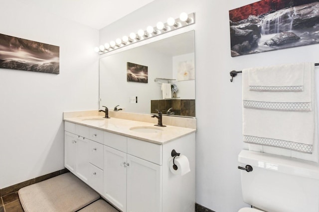 bathroom featuring tile patterned floors, vanity, and toilet