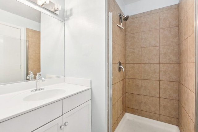 bathroom featuring vanity and tiled shower