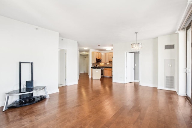 living room featuring a chandelier and wood-type flooring