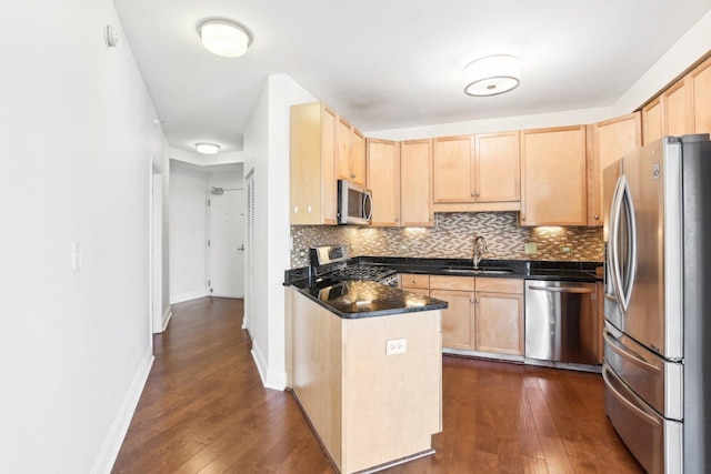 kitchen featuring light brown cabinets, backsplash, stainless steel appliances, and sink