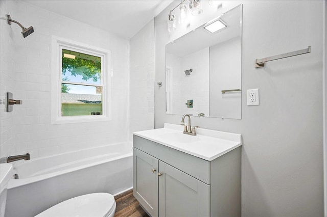 405 N Walnut St, Onarga, IL 60955 - bathroom with toilet, vanity,  shower combination, and wood finished floors