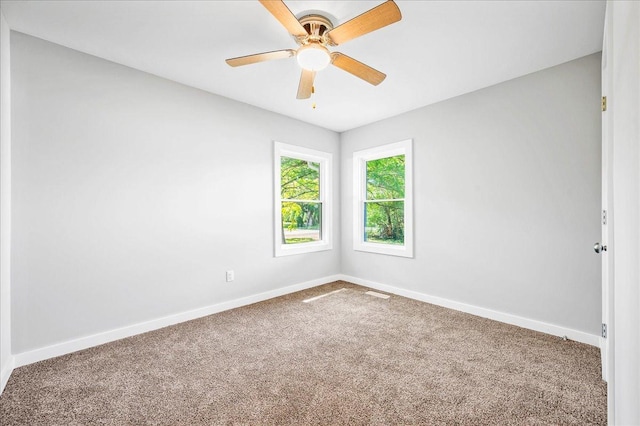 unfurnished room with ceiling fan and carpet floors