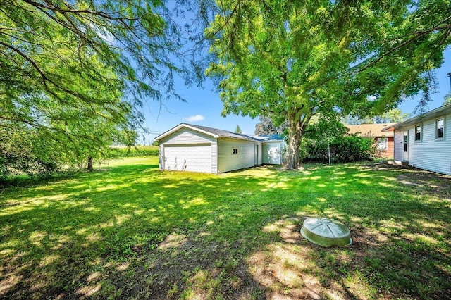 view of yard with an outbuilding and a garage