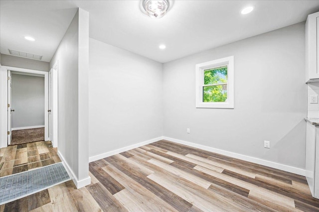 empty room with light hardwood / wood-style flooring