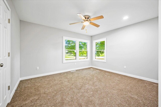 405 N Walnut St, Onarga, IL 60955 - carpeted empty room with a ceiling fan, baseboards, and recessed lighting